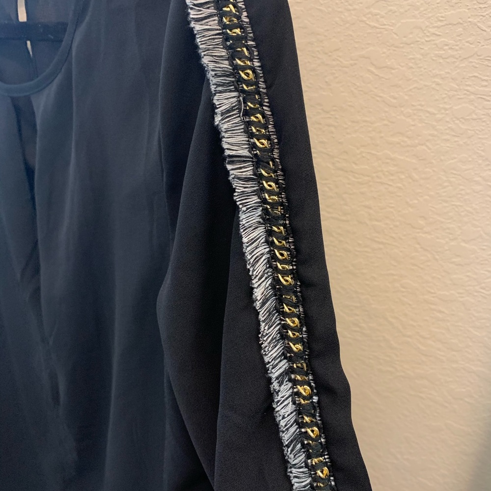 The ethereal black blouse with ruffles on sleeves